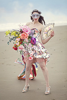 image of a woman with flowers wearing a mask on the beach