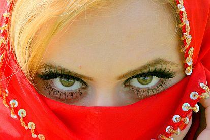 womans brown eyes with red vail