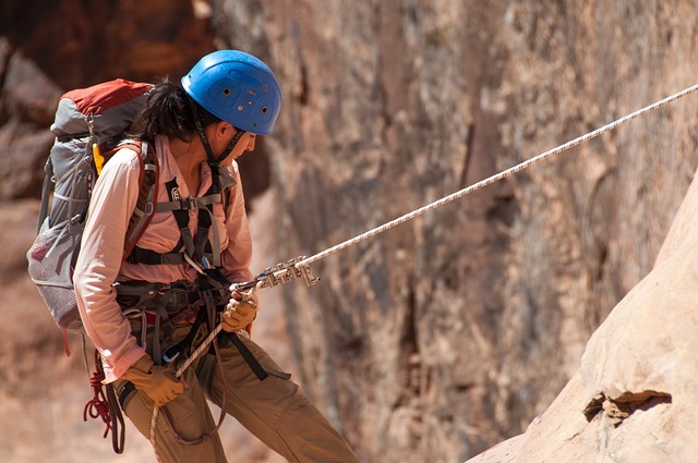 woman repelling down mountain